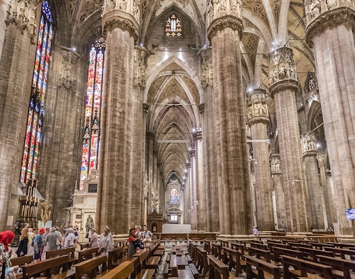 Duomo Cathedral interior in Milan with ornate columns and detailed ceiling.