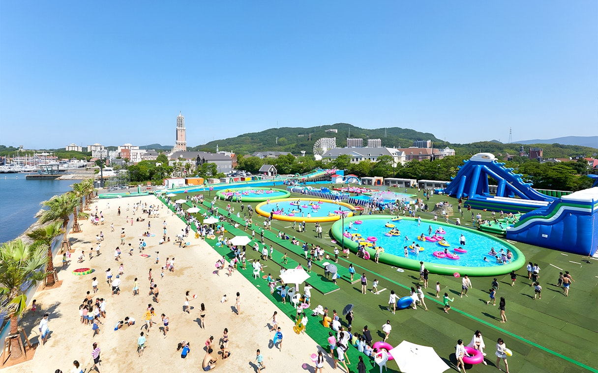 Huis Ten Bosch water park with pools, slides, and beach area in Nagasaki, Japan.