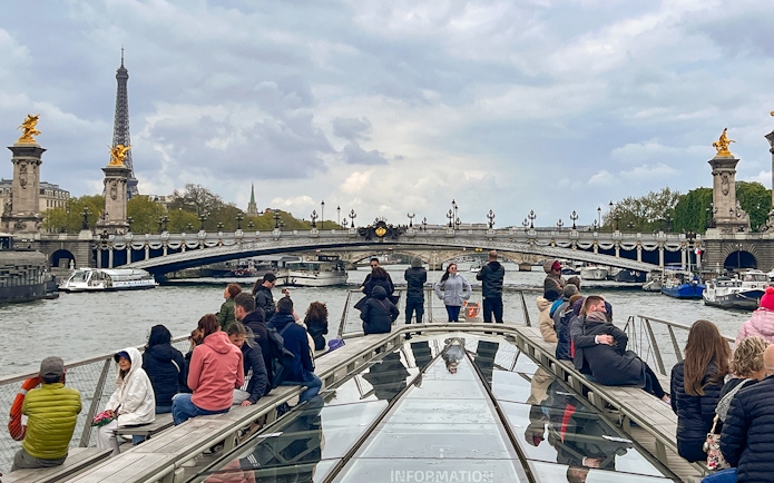 Seine River cruise with view of Eiffel Tower and Pont Alexandre III bridge in Paris.