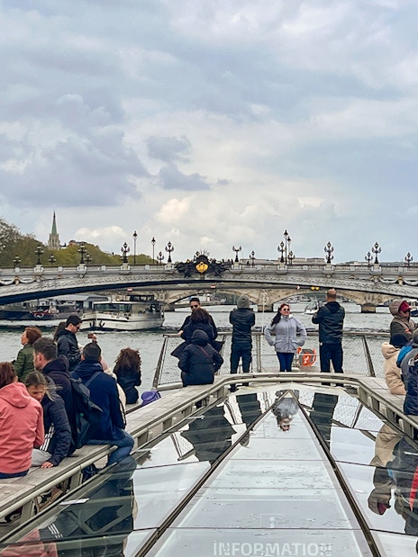 Seine River cruise with view of Eiffel Tower and Pont Alexandre III bridge in Paris.