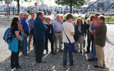 Group of tourists on a guided tour near Elbphilharmonie, Hamburg.