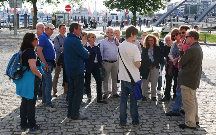 Group of tourists on a guided tour near Elbphilharmonie, Hamburg.