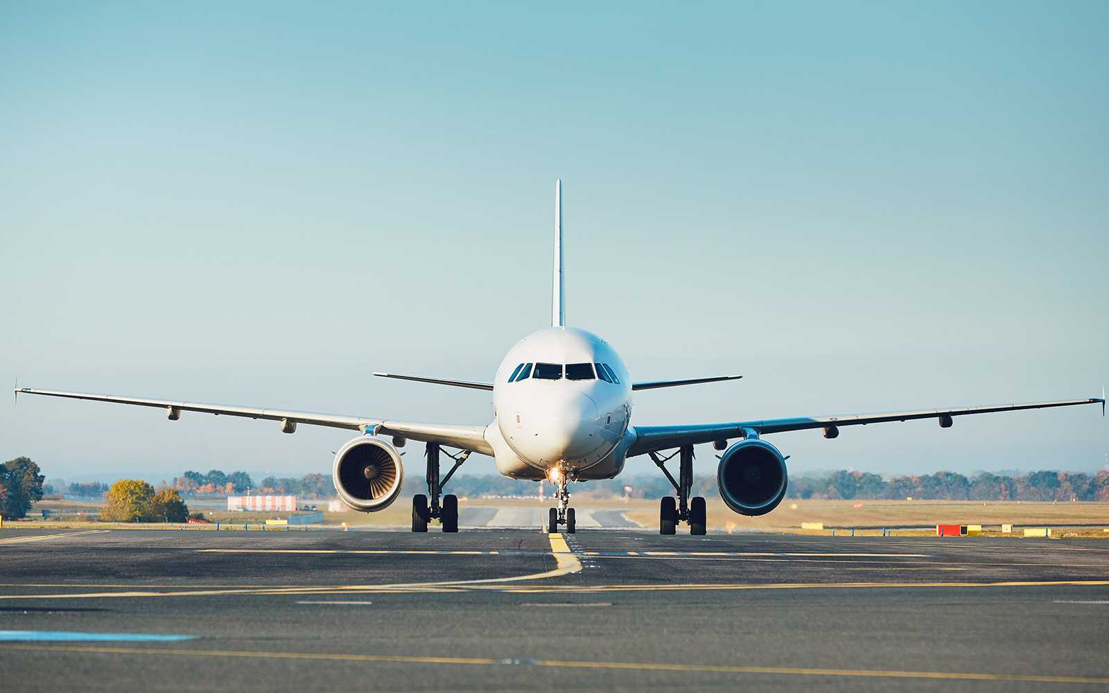 Airplane on runway preparing for takeoff at an airport.