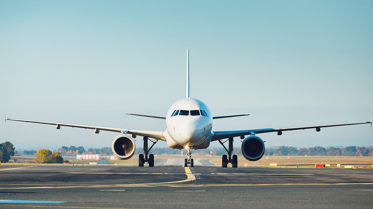Airplane on runway preparing for takeoff at an airport.
