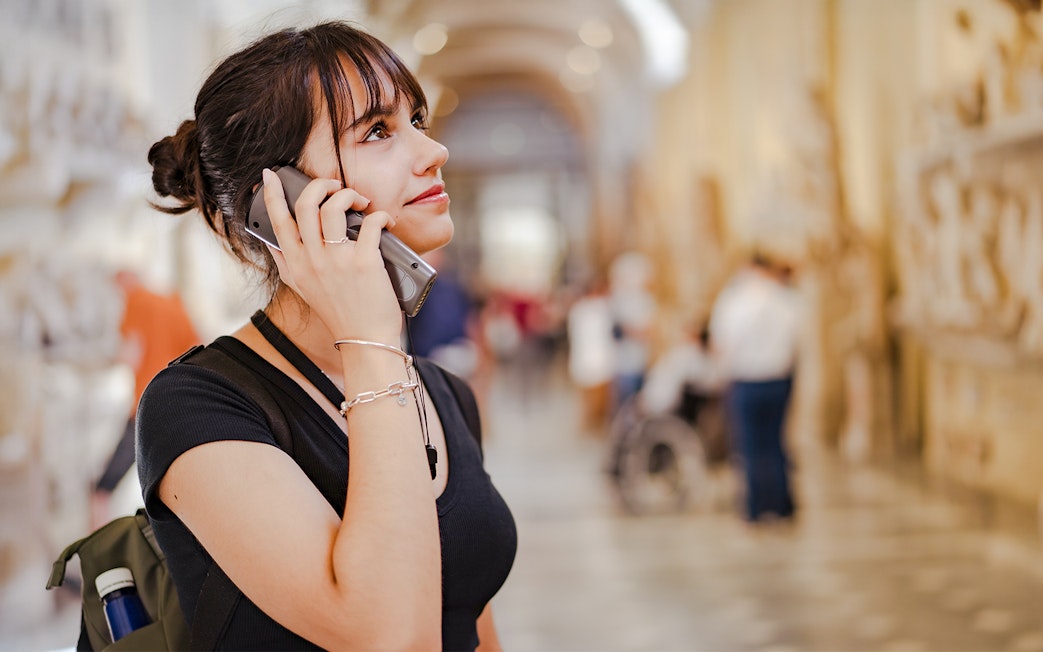 Woman using audio guide at Palace of Parliament.