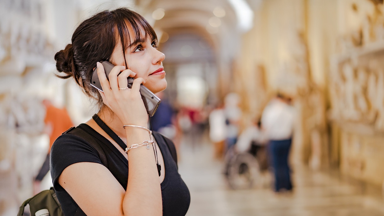 Woman using audio guide at Palace of Parliament, Bucharest.