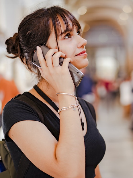Woman using audio guide at Palace of Parliament.