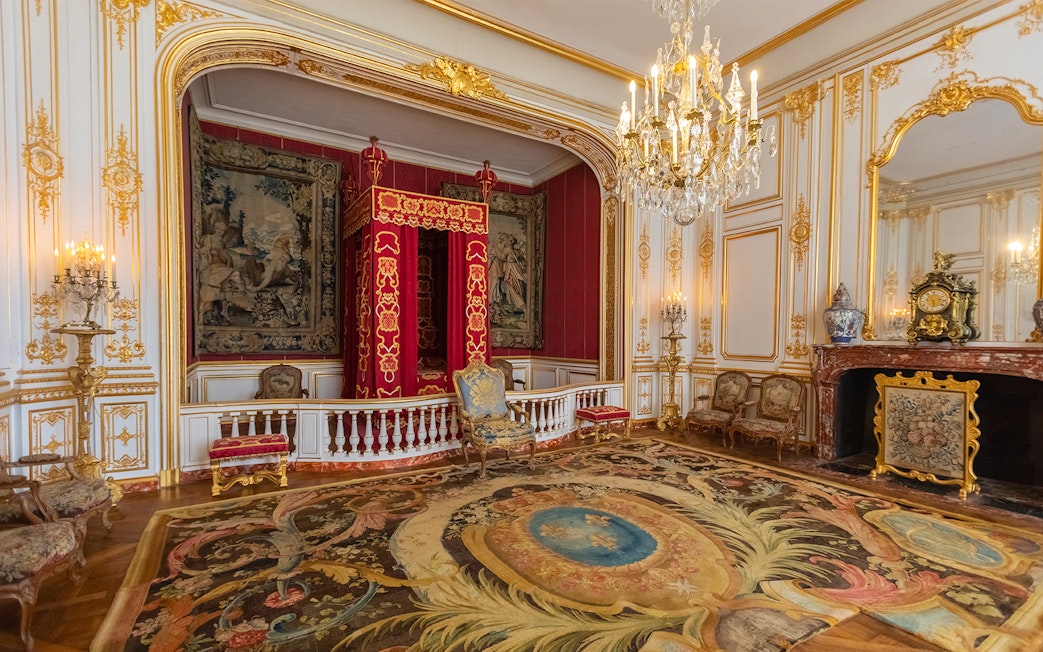 Interiors of a lavish room with ornate decor in Château de Chenonceau, Loire Valley.