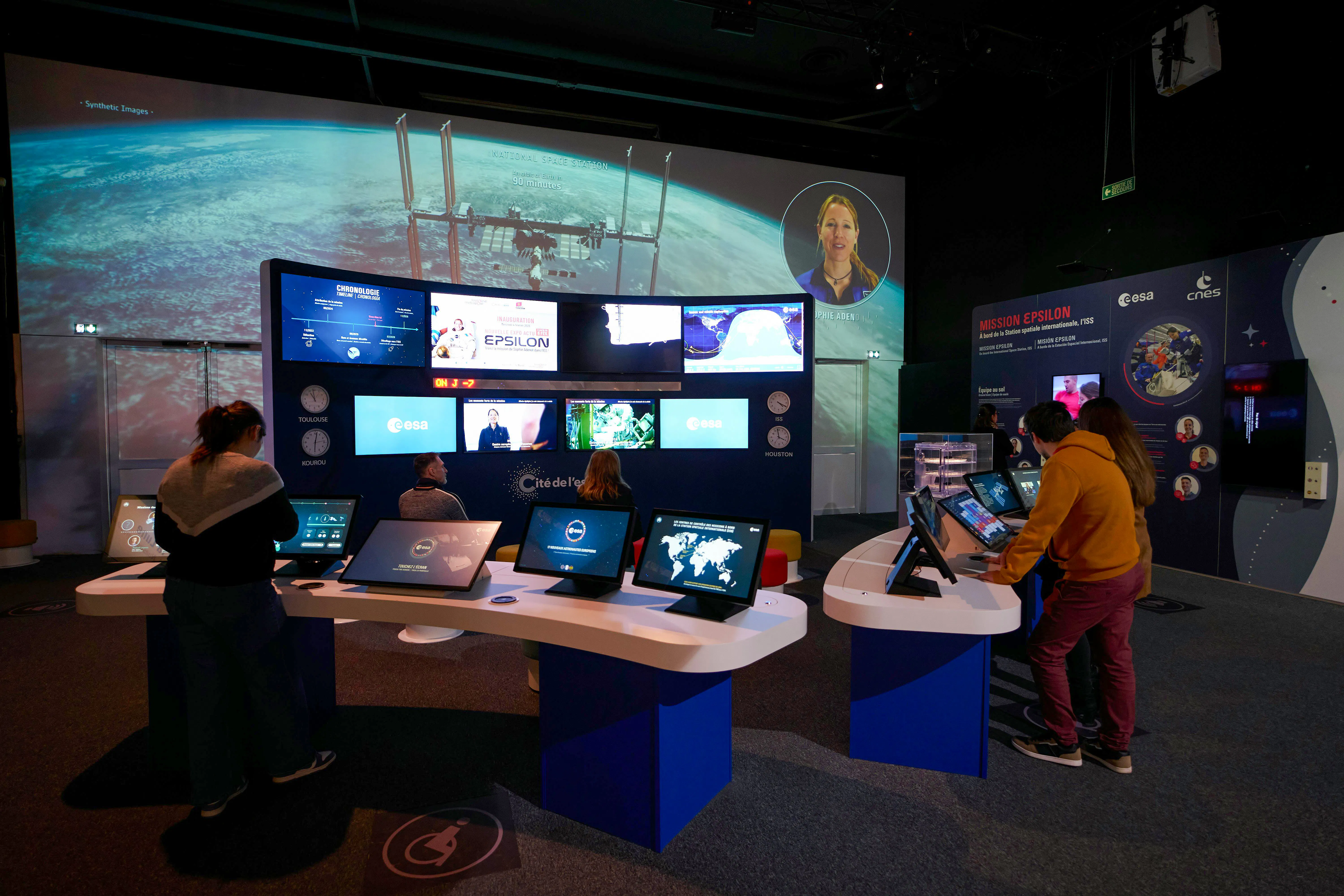 Interactive space exhibit at Cité de l’Espace, France, featuring mission control displays and educational screens.