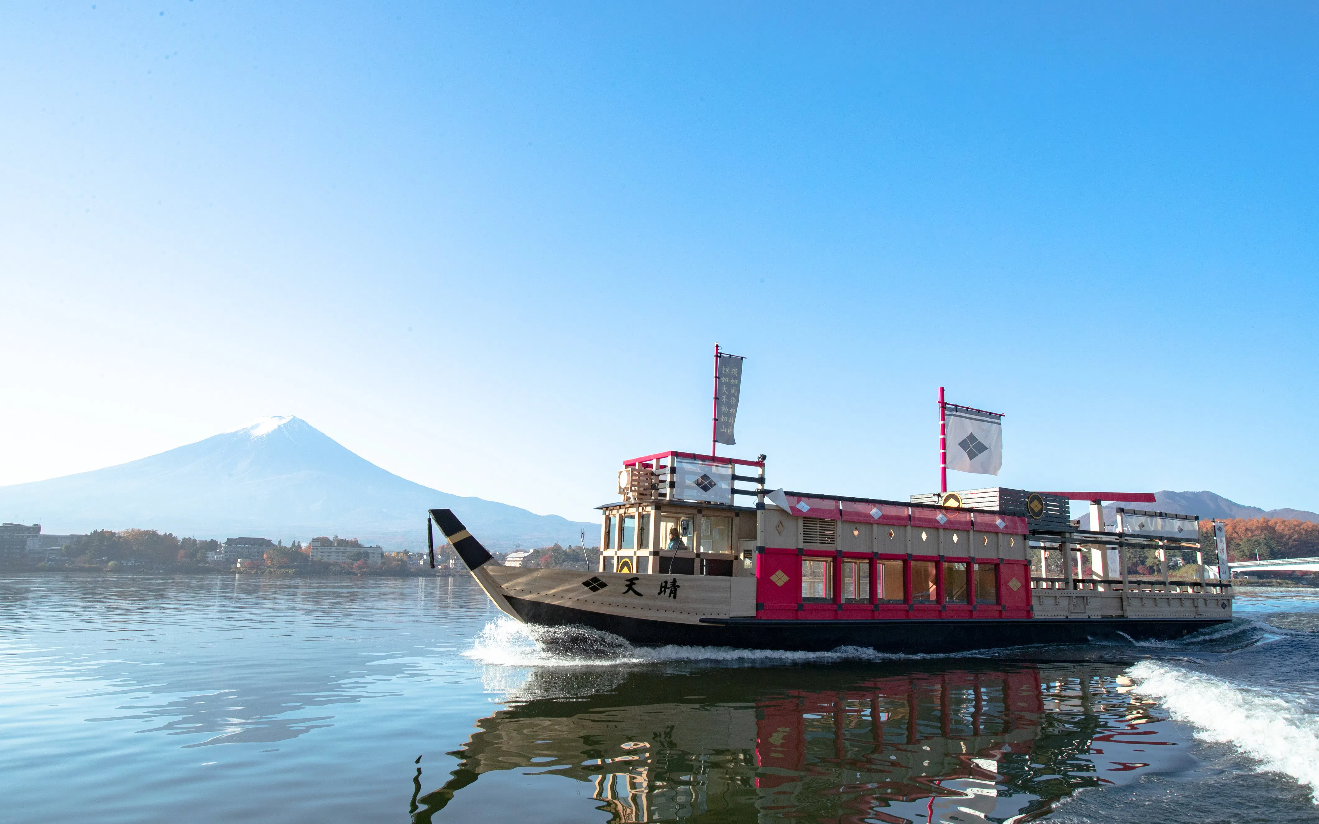 Cruise boat on Lake Kawaguchi with Mount Fuji in the background.