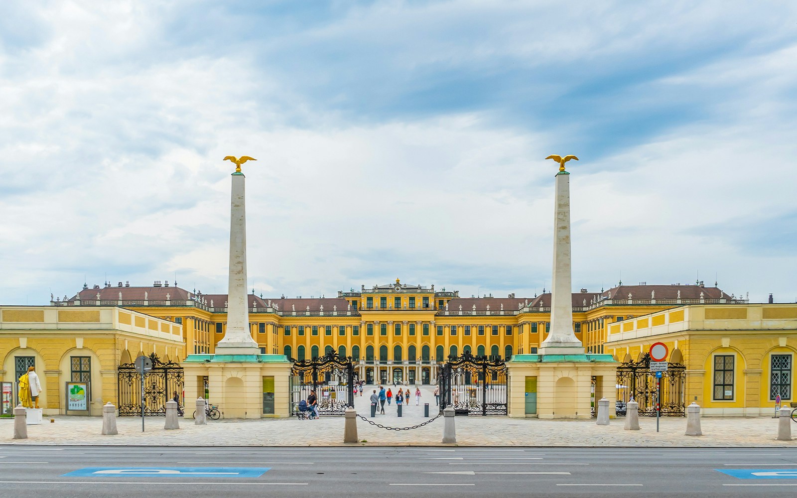 Schönbrunn Palace entrance with columns and gates in Vienna, Austria.