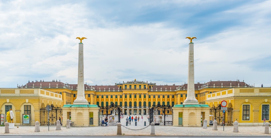 Schönbrunn Palace entrance with columns and gates in Vienna, Austria.