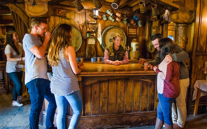 Visitors enjoying drinks at the Hobbiton Movie Set's Green Dragon Inn, New Zealand.