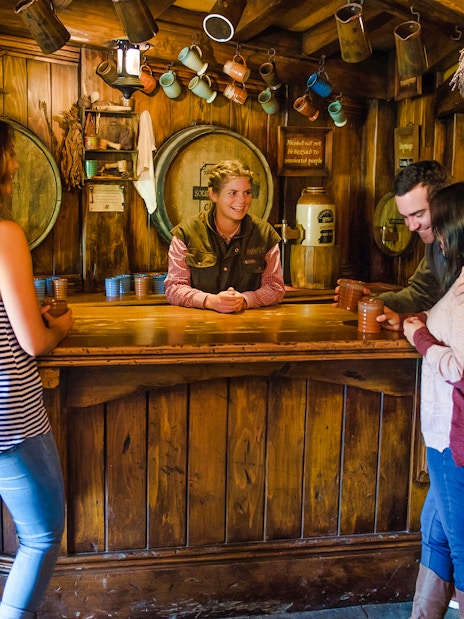 Visitors enjoying drinks at the Hobbiton Movie Set's Green Dragon Inn, New Zealand.