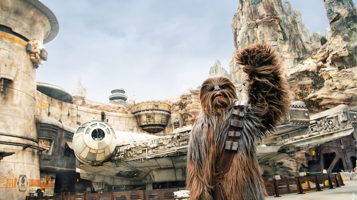 Chewbacca at Star Wars Galaxy's Edge, Disneyland Park, California, with Millennium Falcon.
