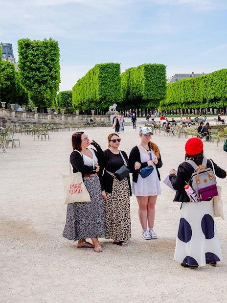 Guide with tourists in a Paris park during Emily in Paris Locations Walking Tour.