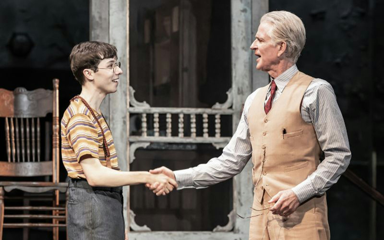 Two actors shaking hands on stage during a performance of "To Kill A Mockingbird.