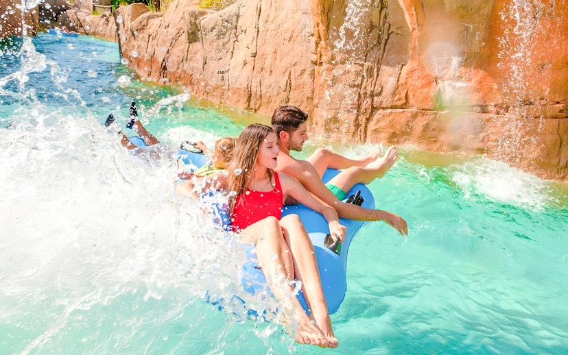 People enjoying a wild river ride at The Land of Legends water park.