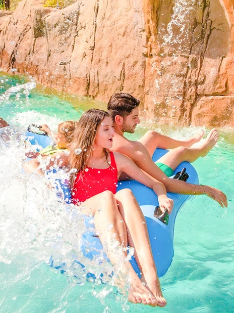 People enjoying a wild river ride at The Land of Legends water park.