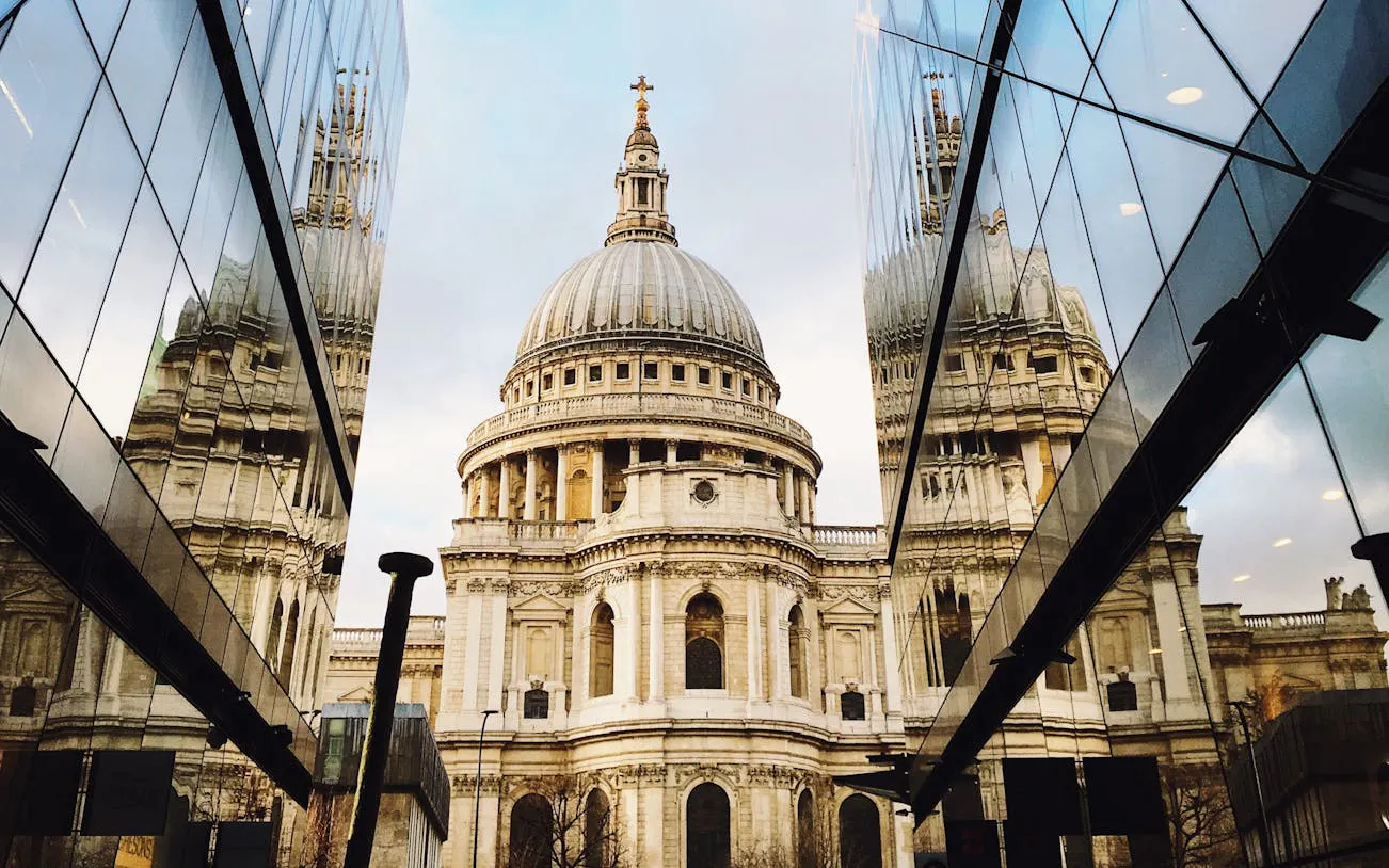 St. Paul's Cathedral dome viewed between modern glass buildings, London.