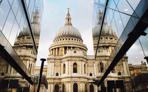 St. Paul's Cathedral dome viewed between modern glass buildings, London.