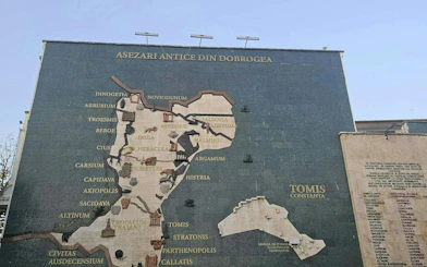 Mosaic map of ancient Dobrogea settlements on a wall in Constanta, featuring Tomis.