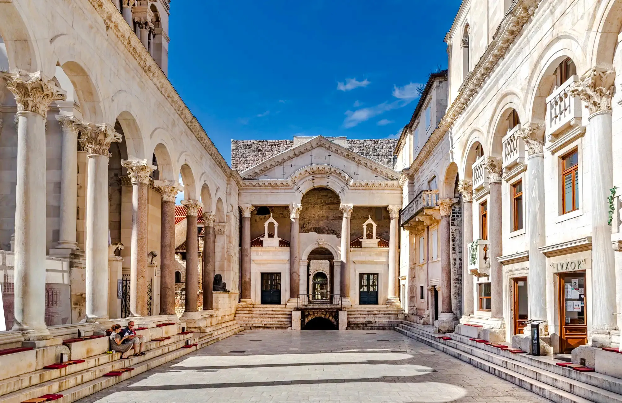 Diocletian's Palace courtyard with ancient columns and arches in Split, Croatia.