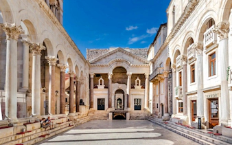 Diocletian's Palace courtyard with ancient columns and arches in Split, Croatia.