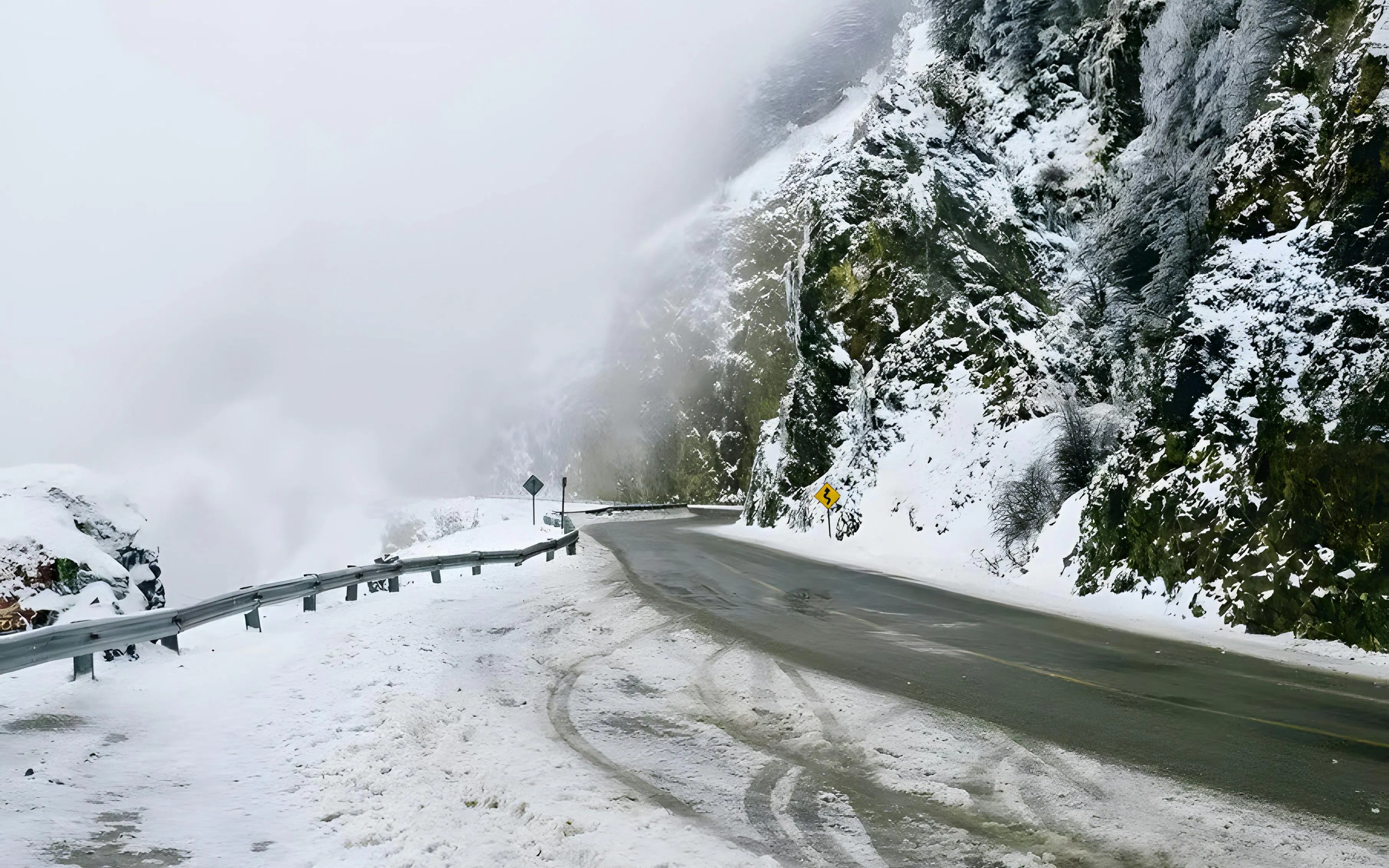 Snow-covered mountain road in Ushuaia during a full day snow experience.