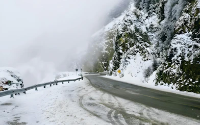 Snow-covered mountain road in Ushuaia during a full day snow experience.