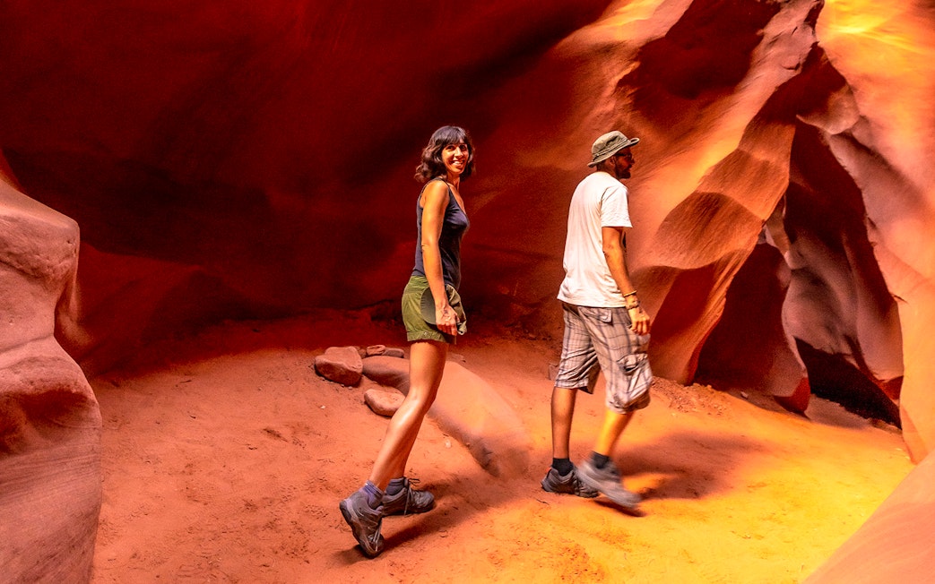 Young couple exploring Lower Antelope Canyon, Arizona.