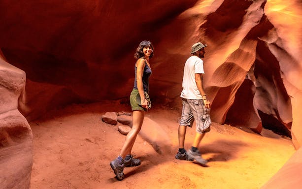 Young couple exploring Lower Antelope Canyon, Arizona.