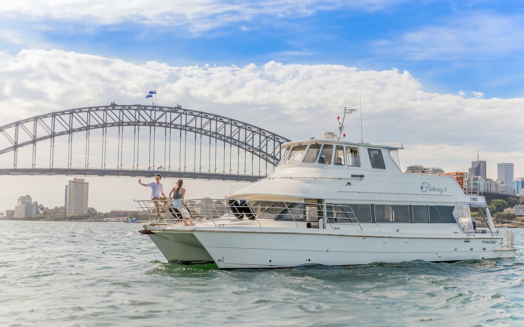 Cruise boat near Sydney Harbour Bridge during Vivid Sydney event.