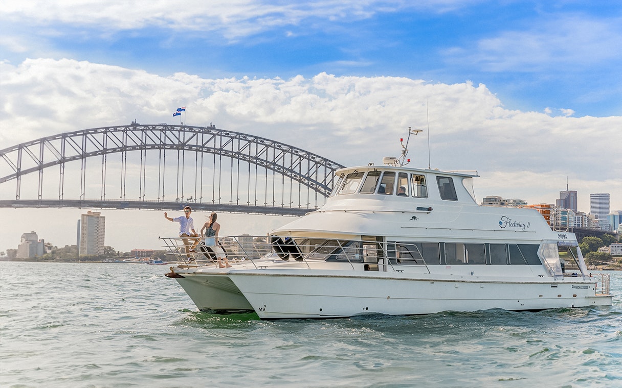 Cruise boat near Sydney Harbour Bridge during Vivid Sydney event.