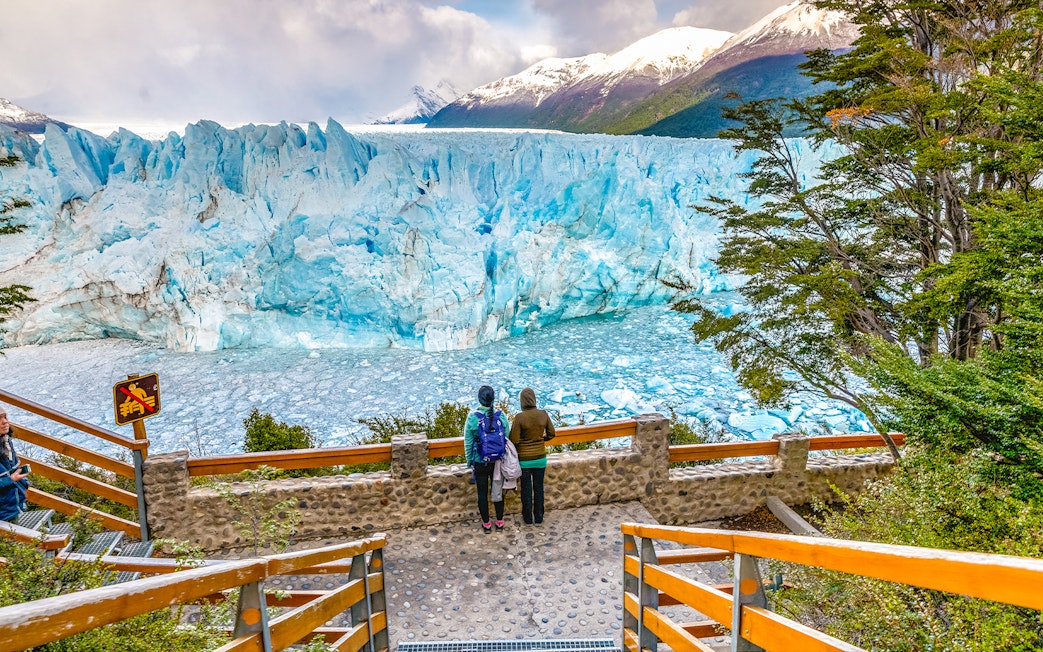 Visitors observing Perito Moreno Glacier from viewing deck in Patagonia, Argentina.