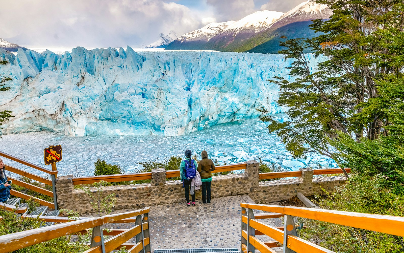 Visitors observing Perito Moreno Glacier from viewing deck in Patagonia, Argentina.