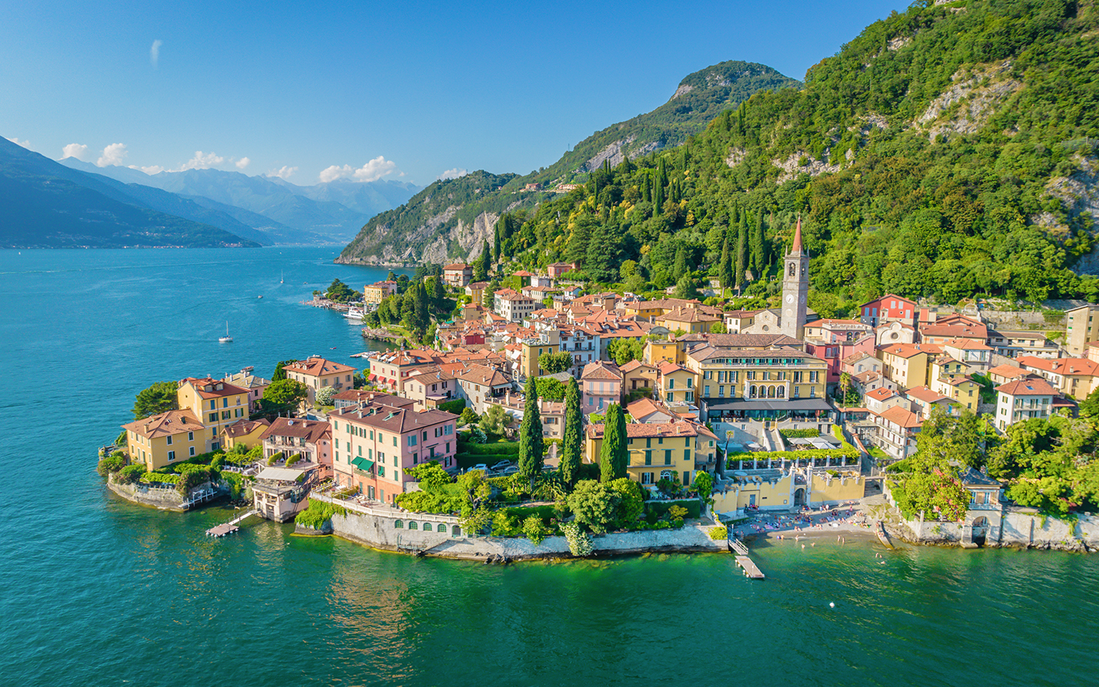 Lake Como view with boats and Varena City in the background, Italy.