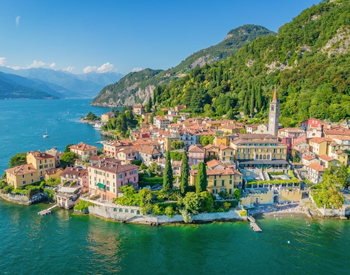Lake Como view with boats and Varena City in the background, Italy.