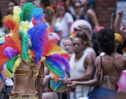Colorful parade at Paris Carnival Tropiques en Fête, Paris, featuring vibrant costumes and lively street performers.