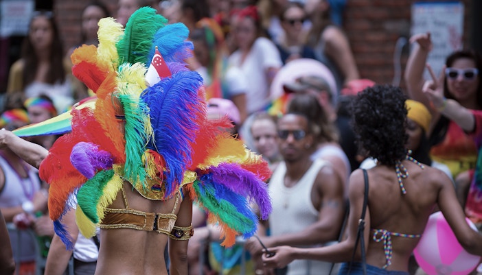Colorful parade at Notting Hill Carnival, London, featuring vibrant costumes and lively street performers.