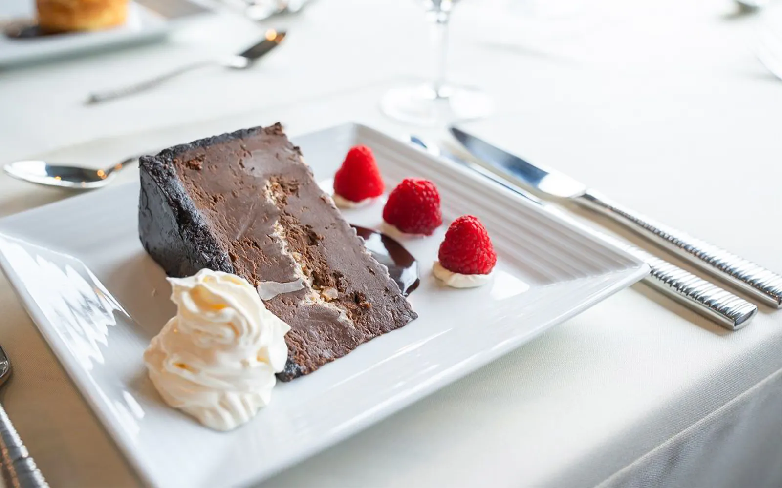 Chocolate cake with raspberries and cream on San Diego Premier Dinner Cruise.