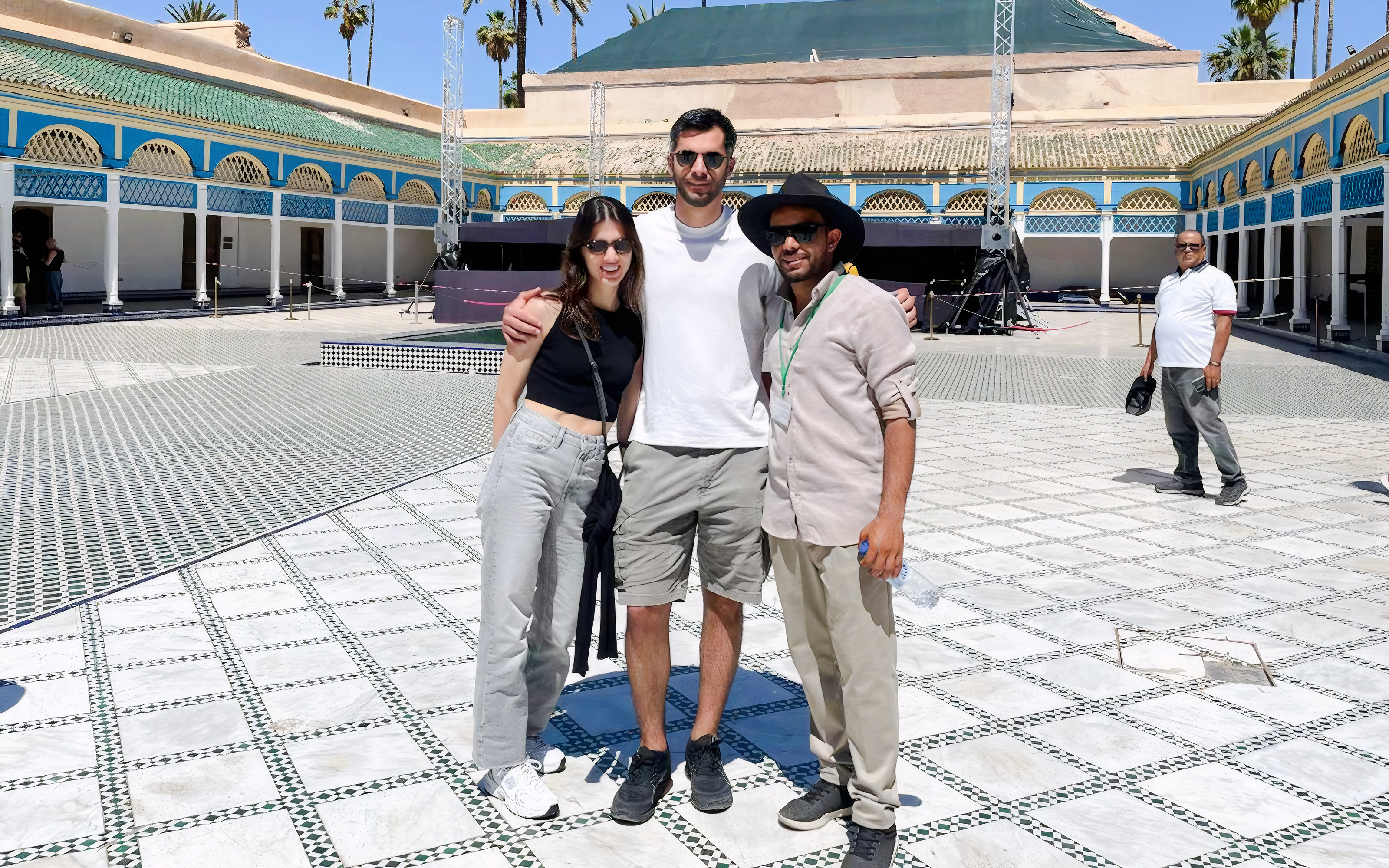 Tourists with a guide at Bahia Palace courtyard in Marrakech.