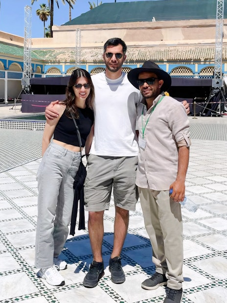 Tourists with a guide at Bahia Palace courtyard in Marrakech.