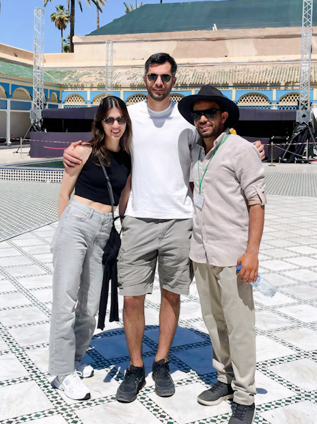 Tourists with a guide at Bahia Palace courtyard in Marrakech.