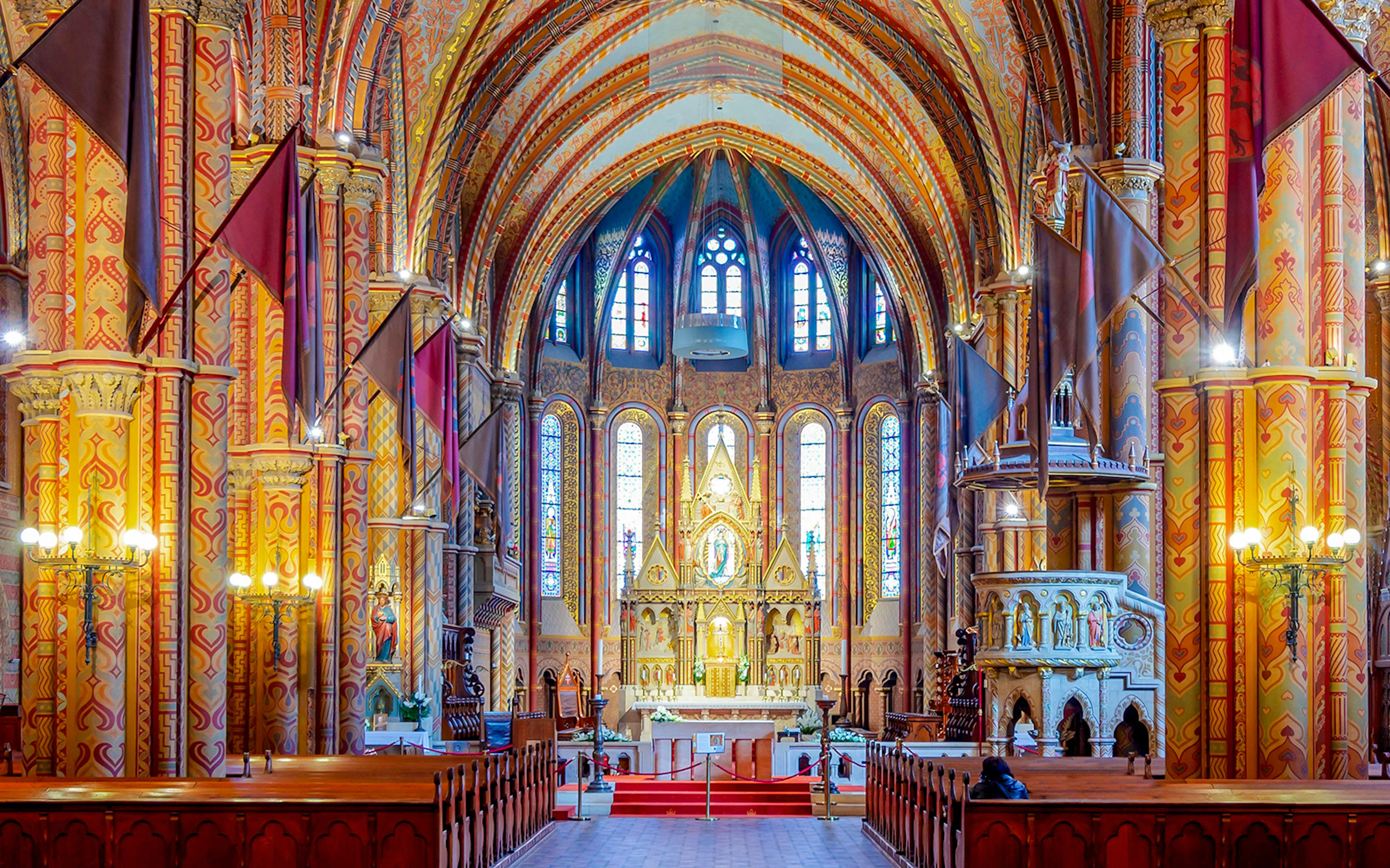 Interiors of Matthias Church with ornate columns and stained glass, Fisherman's Bastion, Budapest.