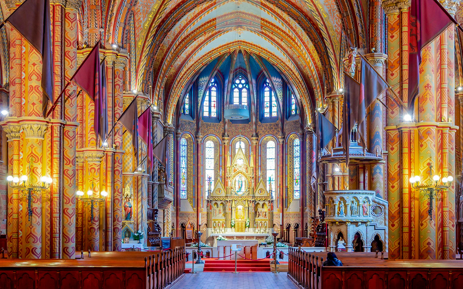 Interiors of Matthias Church with ornate columns and stained glass, Fisherman's Bastion, Budapest.