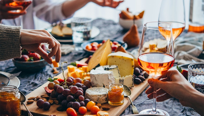 Cheese and charcuterie board with wine at a West End London restaurant.