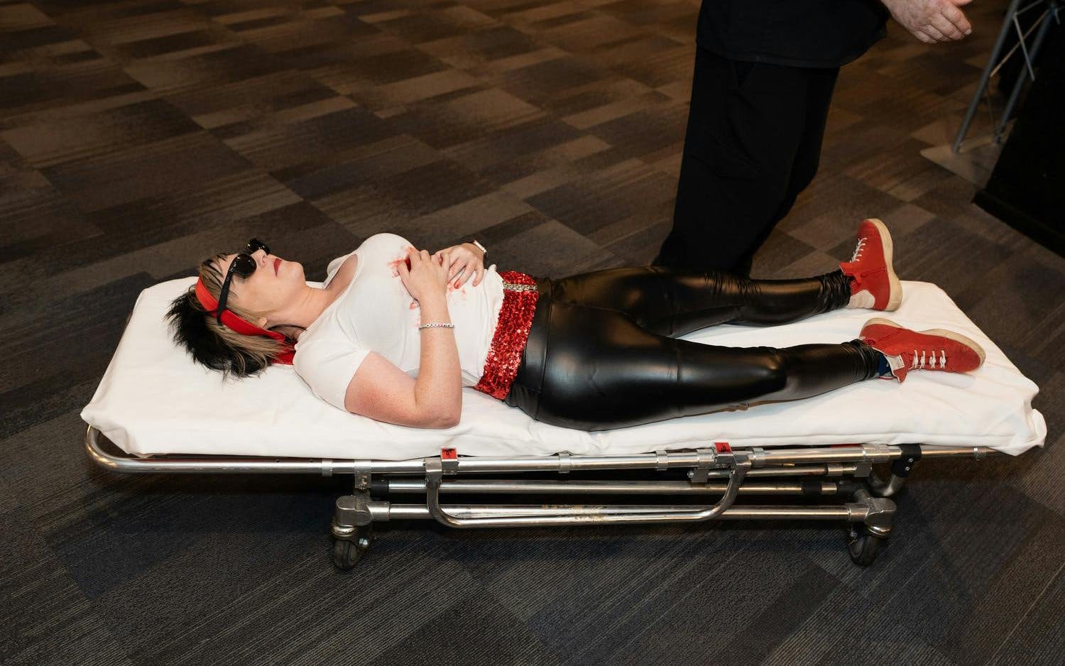Performer in costume on stretcher during "Marriage Can Be Murder" show, Las Vegas.