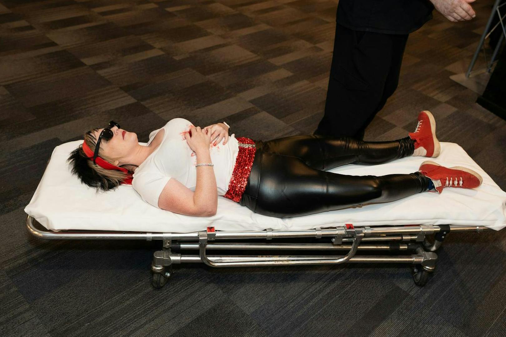 Performer in costume on stretcher during "Marriage Can Be Murder" show, Las Vegas.
