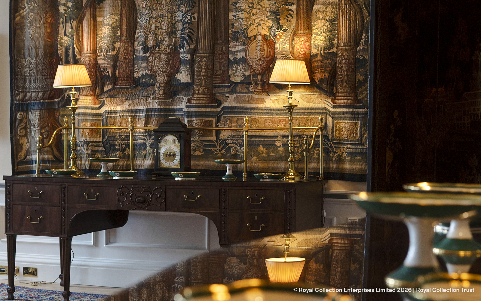 Antique desk with clock and lamps in Queen Elizabeth II Private Apartments, Palace of Holyroodhouse.